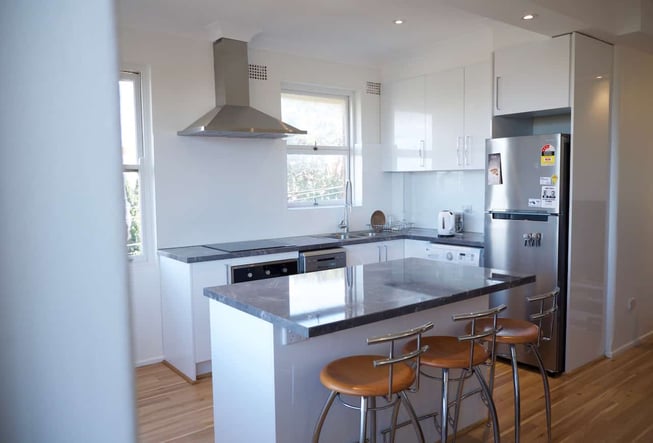 The kitchen was revamped with sleek, stainless steel appliances and a marble benchtop