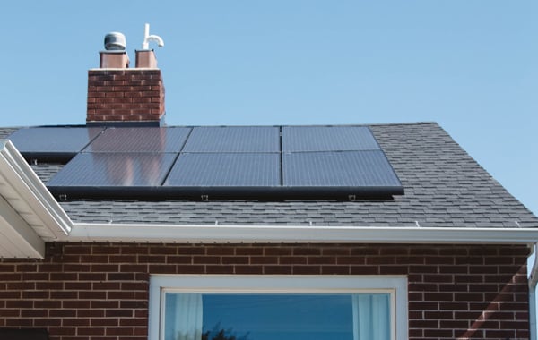 brown brick house with solar panel installed