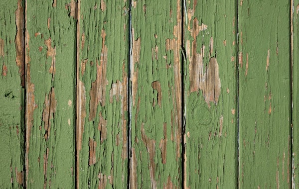 green painted fence damage