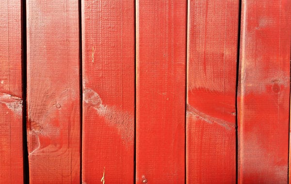red wooden paint fence