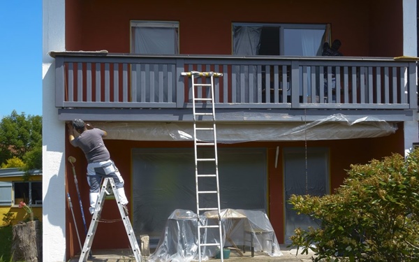 man repair the paint on the exterior