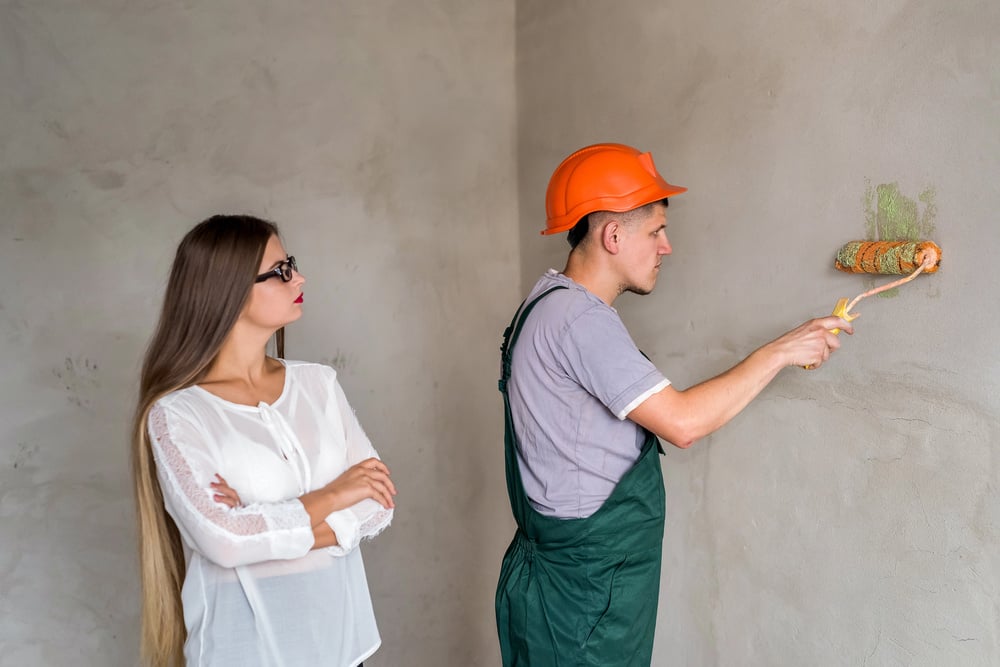 client-looking-at-painter-tradie-serviceseeking