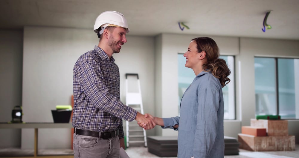 home-reno-contractor-and-homeowner-smiling-serviceseeking