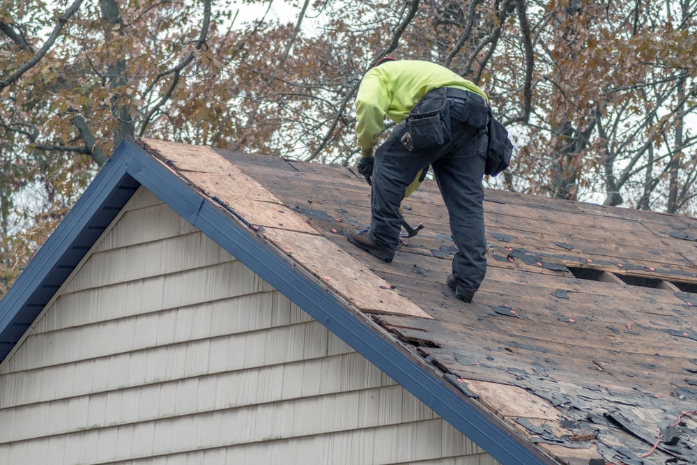 roofer-working-on-old-roof-serviceseeking